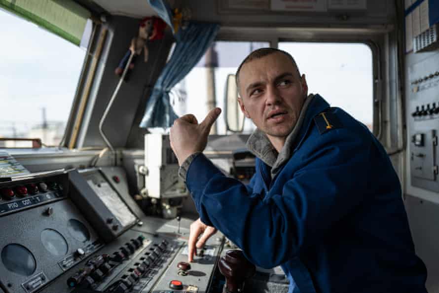 Roman Gasyuk, an evacuation train diver, in his cabin at a stop in Lviv doing final checks before departure to Przemyśl, Poland