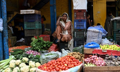 A vendor waiting for customers at a vegetable market in Delhi.