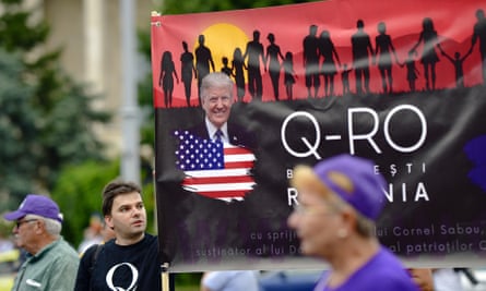 Romanian supporters of QAnon take part in a rally against the government’s measures to prevent the spread of Covid-19 infections in Bucharest, Romania.