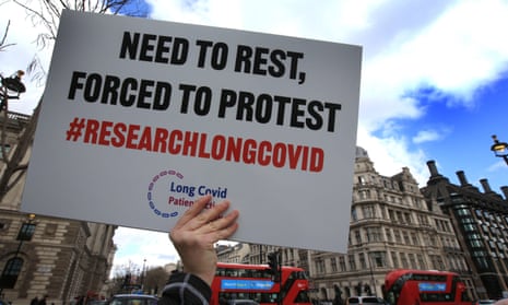 A protester holds up a placard demanding research into long Covid during a demonstration in London, March 2022. 