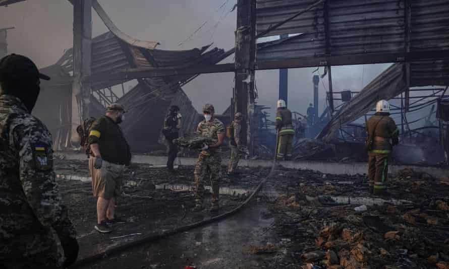 Rescue teams work at a site of a shopping mall hit by a Russian missile strike in Kremenchuk, Ukraine.