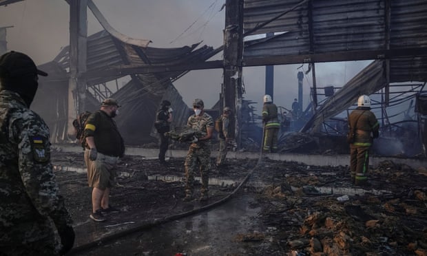 Rescue crews seen dismantling debris from a shopping mall hit by a Russian missile strike in Kremenchuk, Ukraine.