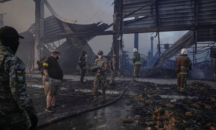 Rescue teams work at a site of a shopping mall hit by a Russian missile strike in Kremenchuk, Ukraine.