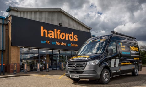 A Halfords van outside a Halfords store