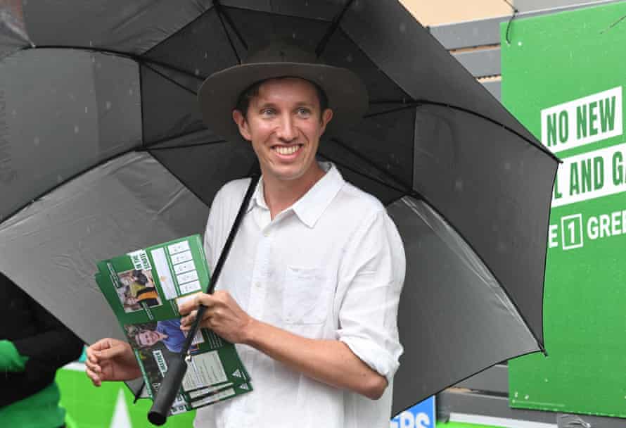 Max Chandler-Mather, Greens candidate in the seat of Griffith, hands out how-to-vote leaflets at the Brisbane State high polling booth on Saturday.