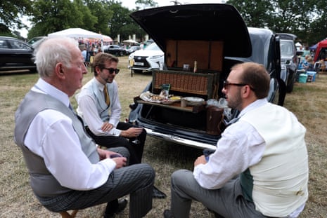 Racegoers have a picnic in a car park ahead of the day's races.
