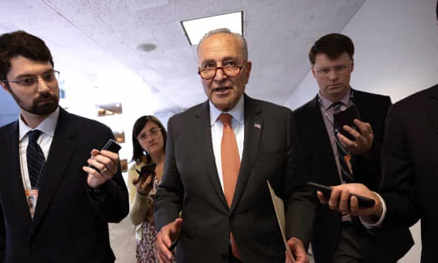 chuck schumer surrounded by reporters