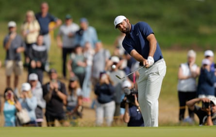 Scottie Scheffler chips on to the 12th green.