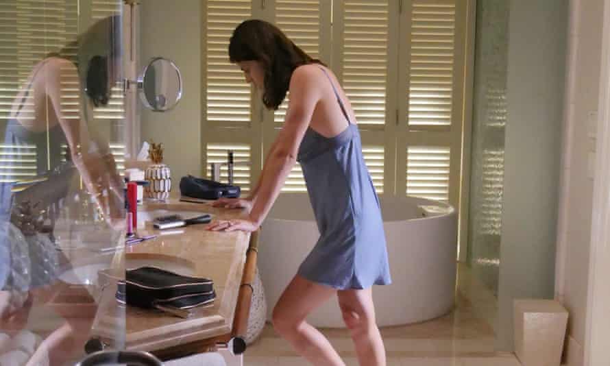 Alexandra Daddario as Rachel, leaning on her dressing-table in a slip