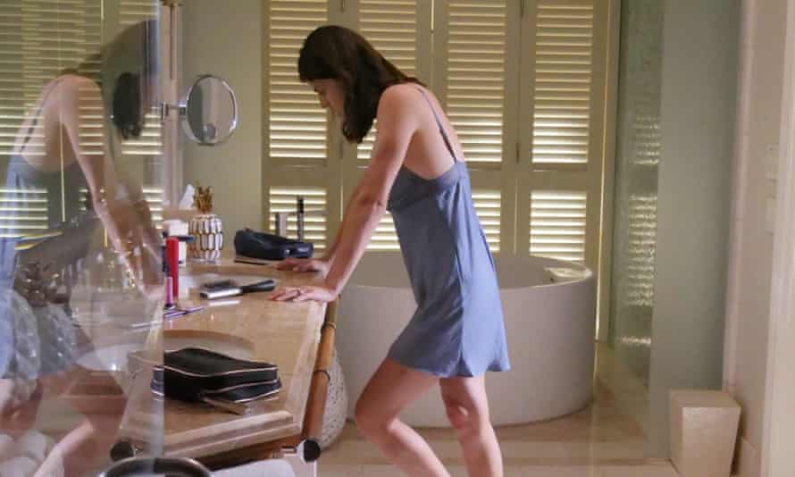 Alexandra Daddario as Rachel, leaning on her dressing-table in a slip