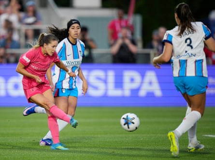 Ashley Sanchez takes a shot between two defenders.