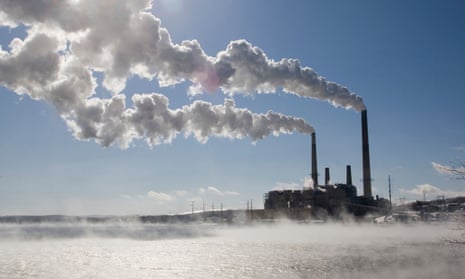 Coal-fired power plant in winter with emissions blowing