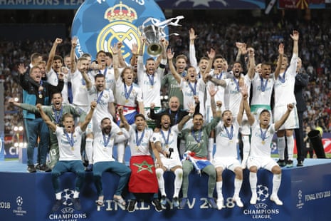 Real Madrid’s Sergio Ramos lifts the trophy as his team-mates celebrate.