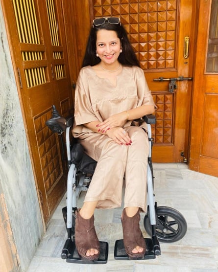Payal Shrishrimal pictured sitting in her wheelchair in front of a wooden door