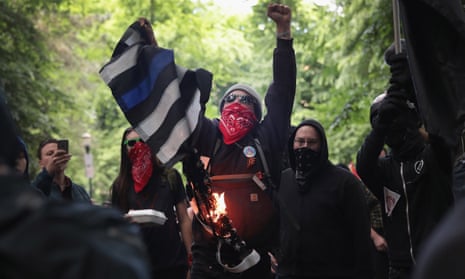 Antifascist demonstrators burn a Blue Lives Matter flag during a protest in June 2017 in Portland, Oregon.