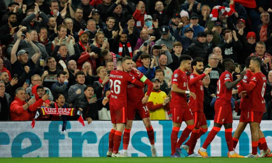 Liverpool captain Jordan Henderson is congratulated by his team-mates after his cross is deflected into the net for the opening goal of the night.