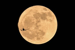 Un avión pasa frente a la luna llena, Chongqing, suroeste de China.