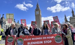 Campaigners holding up a protest banner saying 'solar belongs on roofs' with Big Ben in background