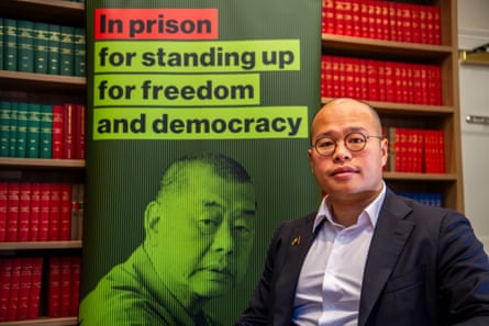 Sebastien Lai in front of a picture of his father at a media briefing