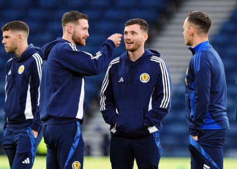 Anthony Ralston pretends to place a cap on Andy Robertson's head.