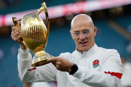 England head coach John Mitchell poses with the Women's Rugby World Cup trophy