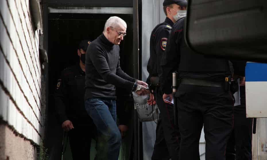Russian historian Yury Dmitriev is escorted by police officers after a court hearing in July.