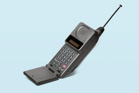 A 90s era mobile phone – a grey flip phone with a large retractable antenna.