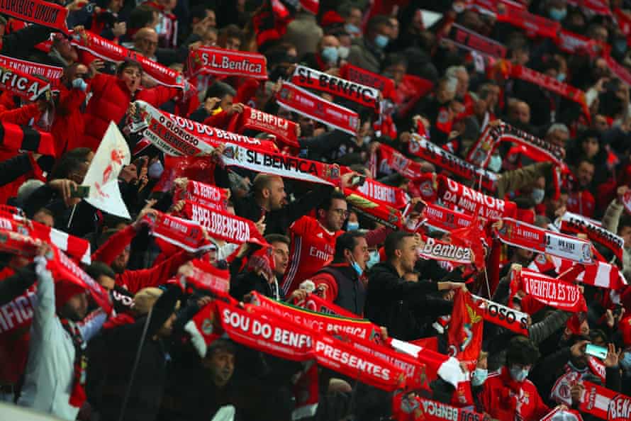 Benfica fans hold scarves inside the stadium.