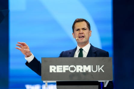 Reform MP Robert Jenrick speaks on stage during the party's annual conference on Saturday