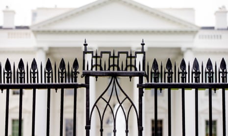 White House is visible through the fence at the North Lawn in Washington.