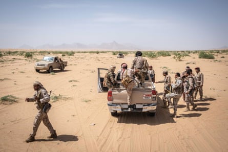 Members of the Assougour Brigade, part of the Yemeni national army, gather in a location in the desert before reaching the frontlines near Al Jubah, a desert area about 50km south of the city of Marib, in 2022