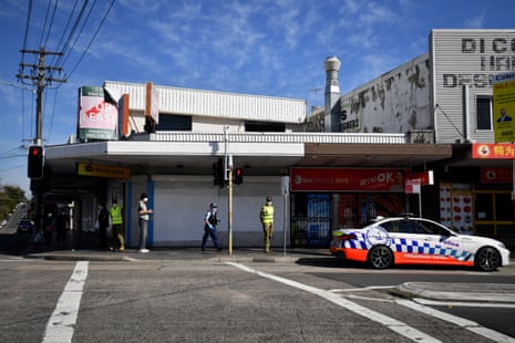 NSW Police and defence force members speak to a man about compliance at Campsie during Sydney’s hard lockdown of some of its most diverse suburbs last year.