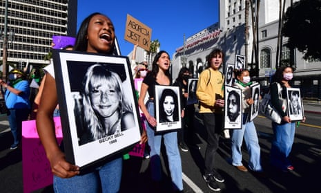 Activists march holding portraits of women who died because of the lack of legal right to abortion on International Women's Day, 8 March, in Los Angeles. 
