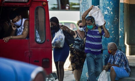 People carry groceries home in Havana