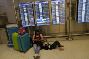 A Brazilian woman and her child wait for their flight at Miami airport.