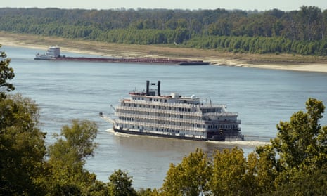 This American Heritage paddlewheeler passes a tow moored on the Louisiana side river bank in Vicksburg on Tuesday.