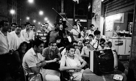 People watch the moon landing on a TV put outside by a cafe in Milan.