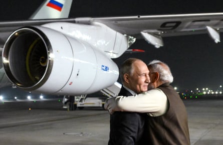 Putin is embraced by Indian prime minister Narendra Modi upon Russian leader’s arrival at Palam air force base in New Delhi on Thursday with part of plane visible behind