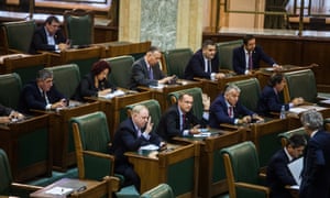 Politicians vote during a Senate meeting at the Romanian Parliament, in Bucharest.