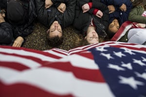 Protesters lie on the ground during a demonstration supporting gun control reform near the White House.