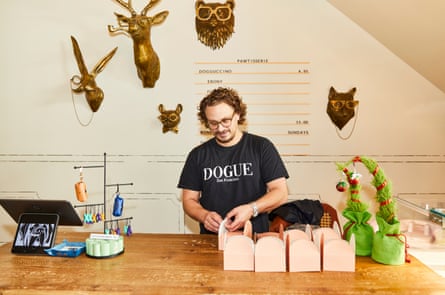 A man standing behind a counter in a dog friendly restaurant