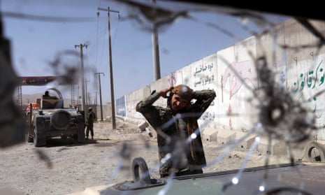 An Afghan soldier keeps watch at a checkpoint on the Ghazni-Kabul highway in Afghanistan.