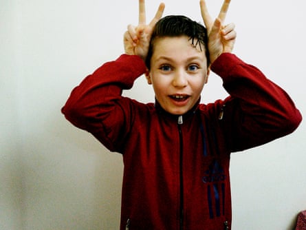 Boy makes horns with his fingers