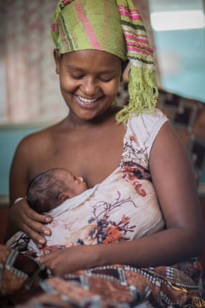 Bikile Aljra breastfeeds her pre-term daughter Leti at the Unicef-supported neonatal intensive care unit in the remote Benishangul-Gumuz region of Ethiopia. Mothers in the ‘kangaroo’ mother care room typically stay for a month or more, until their babies weigh a minimum of 1.8kg. The babies stay bound to their mothers 24/7 for warmth