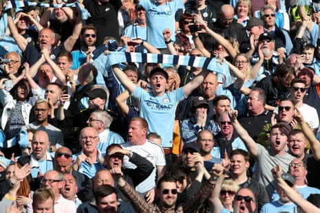 Manchester City fans celebrate as their team are crowned Premier League champions.