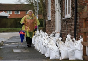 A woman passes sandbags near the River Ouse which has burst its banks in Naburn, near York.