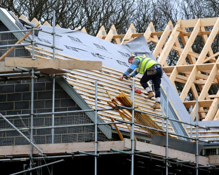 A roofer on an unfinished newbuild at a housing development in Derbyshire