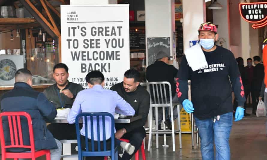People dine at Grand Central Market on 15 March, as indoor dining reopens in Los Angeles.