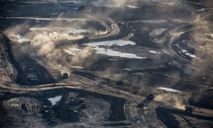 Trucks and machinery along routes within the Suncore tar sands site near to Fort McMurray in Northern Alberta. 