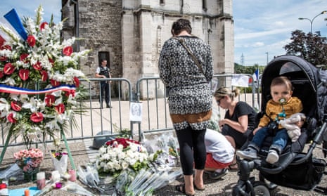 Tributes are paid at a makeshift memorial in front of the Normandy church where Jacques Hamel died.